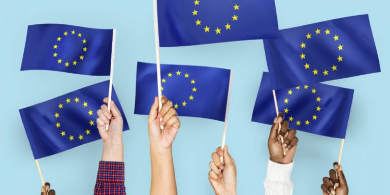 Hands waving flags of the EuropeanUnion